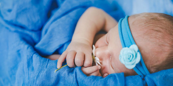 Cute baby sleeping in crib at home
