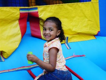 Portrait of smiling cute girl in bouncy castle