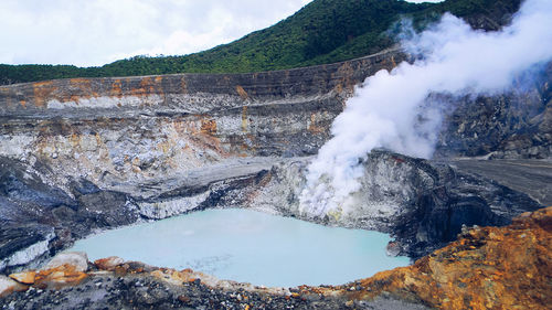 Scenic view of steam emitting from hot spring