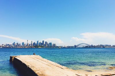 Distant view of sydney harbor bridge against sky