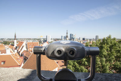 Coin-operated binoculars against buildings in city