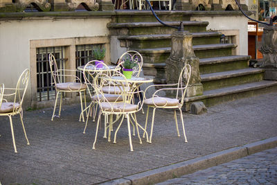 Empty chairs and tables against building in city of gdansk, poland