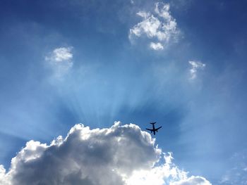 Low angle view of airplane flying in sky