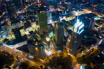 High angle view of city lit up at night