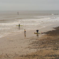 People on beach against sky