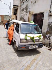 Vehicles on road by buildings in city