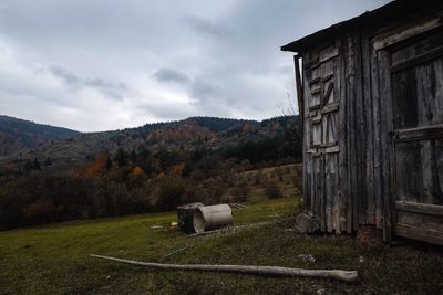 Barn on field against sky