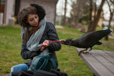 Woman with bird in park