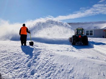 People skiing on snowcapped mountain against sky