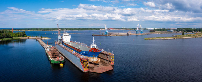 Cargo ship at floating dry dock is being renovated