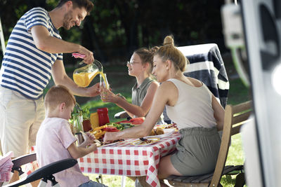 Rear view of people having food