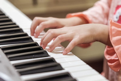 Midsection of man playing piano