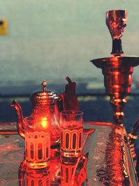 Close-up of illuminated candles on table