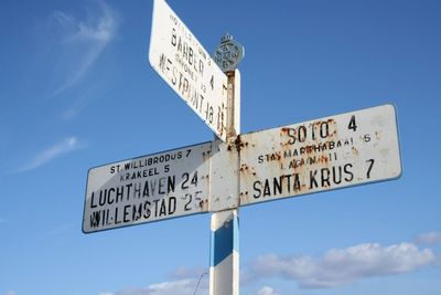 Low angle view of road sign against sky