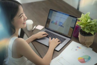 High angle view of businesswoman using laptop