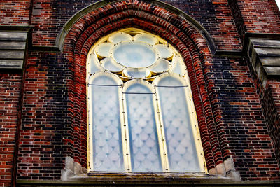 Low angle view of ornate window on building wall