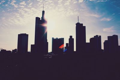 Skyscrapers in city against sky during sunset