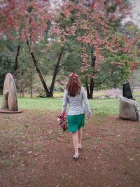 Rear view of woman walking at park