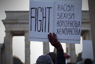 Close-up of woman with text on placard