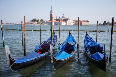 Boats in sea with buildings in background