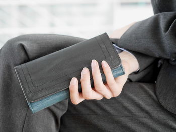 Midsection of businesswoman holding purse