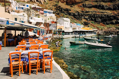 Boats moored on sea by buildings in city