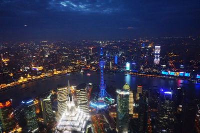 High angle view of city lit up at night