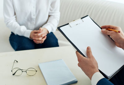 Midsection of man using digital tablet