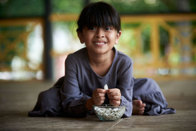 Portrait of young man sitting on table