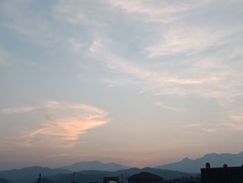 Scenic view of silhouette mountains against sky at sunset