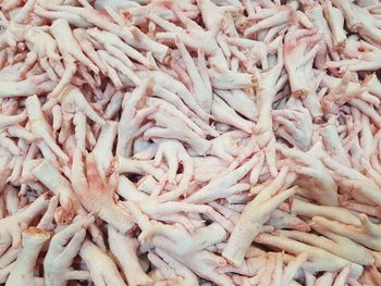 Full frame shot of chicken legs for sale at market