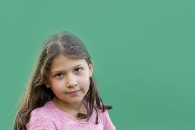 Portrait of a smiling girl against blue background