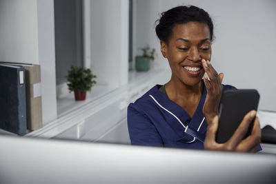 Female doctor having online consultation on smart phone