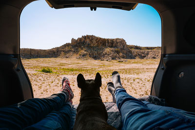 Low section of men sitting in car