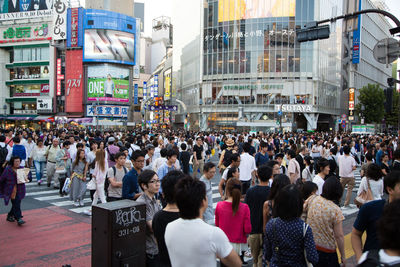 Group of people walking on city street