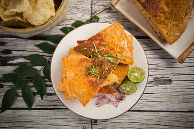 Directly above shot of omelet served in plate on wooden table