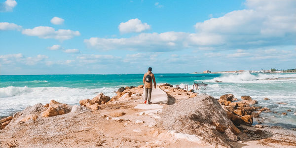 Panoramic view of rocks on beach against sky