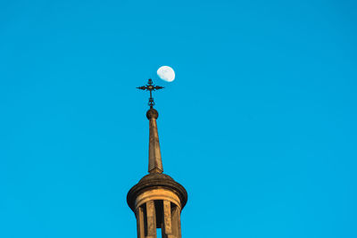 Low angle view of clock tower against blue sky