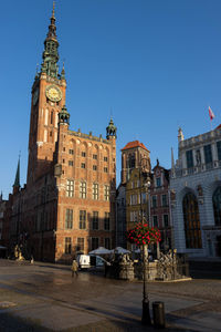Clock tower in city against sky