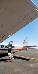 Airplane on runway against sky