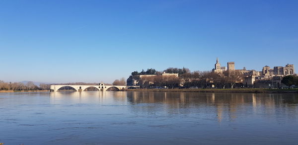 View of bridge over river against clear blue sky