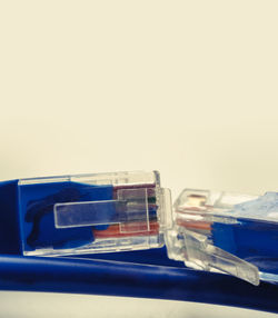 Close-up of objects on table against blue background