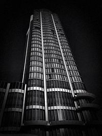 Low angle view of modern building against clear sky at night