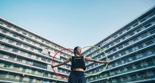 Low angle view of woman man playing  against clear sky