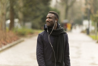 Man with umbrella standing outdoors