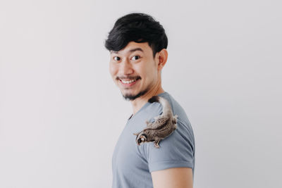 Portrait of smiling young man against white background