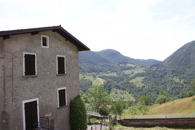 House on mountain against sky