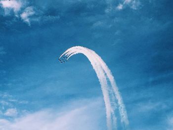 Low angle view of airplane flying against sky