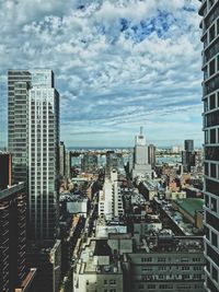 High angle view of cityscape against cloudy sky