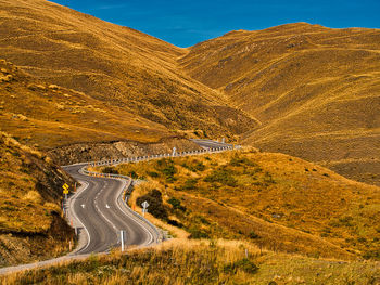 Aerial view of road by mountain against sky